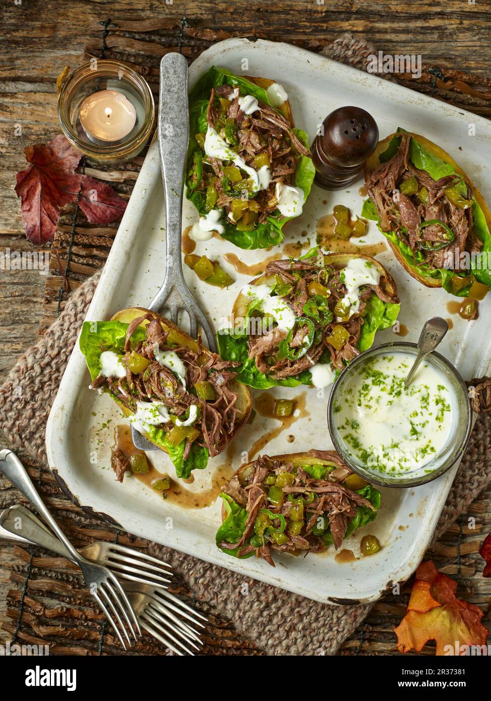 Baked potato skins, filled with spicy minted lamb shoulder and lettuce