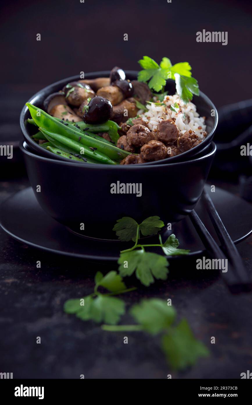 Vegan red quinoa and rice with wild mushrooms, soya chunks, snow peas