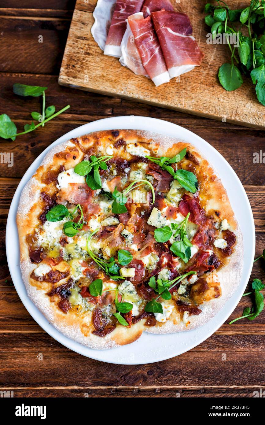 Homemade pizza with blue cheese, pancetta, onion chutney and lamb's