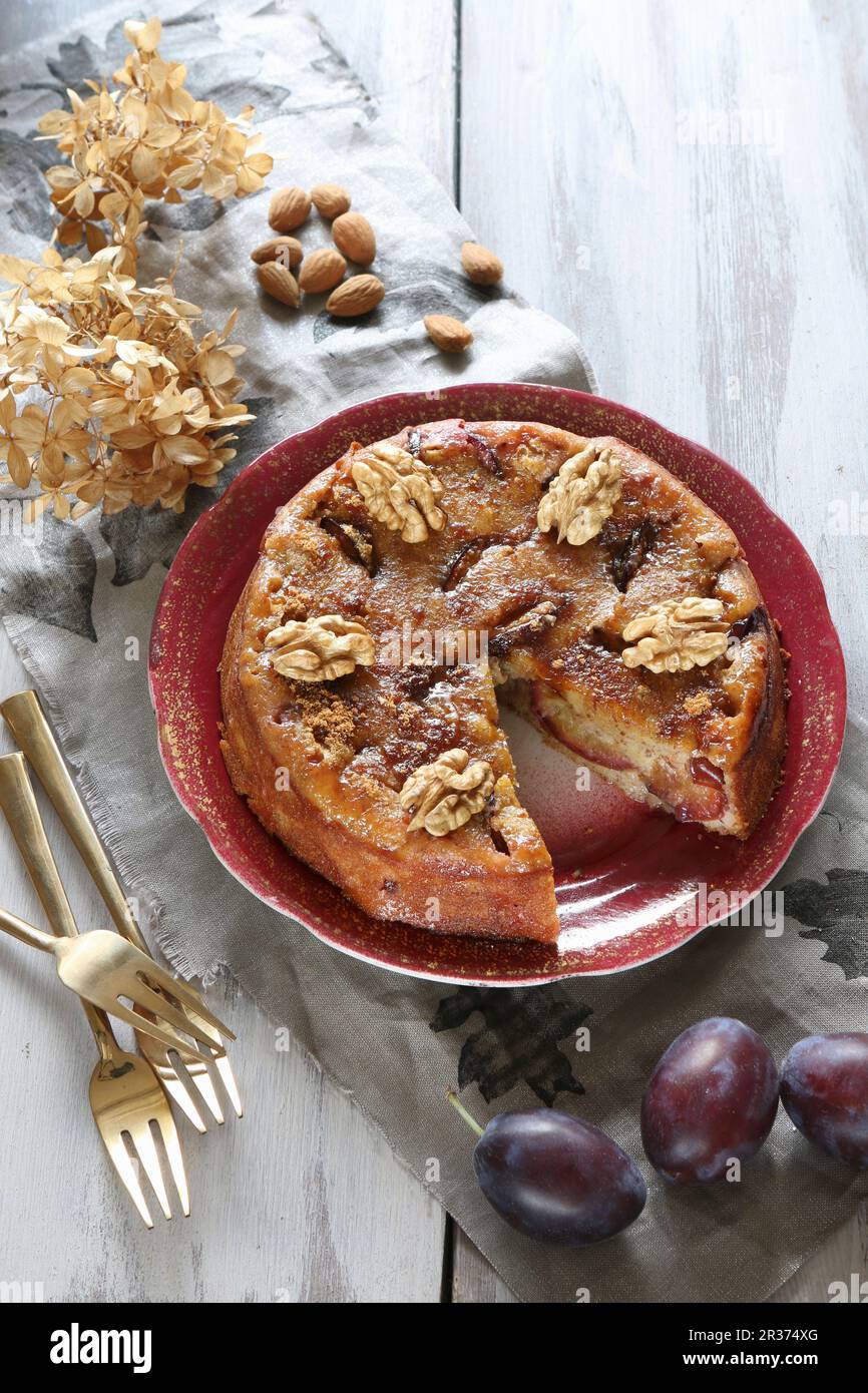 Gluten-free plum cake with walnuts, almonds and coconut blossom sugar (top view) Stock Photo