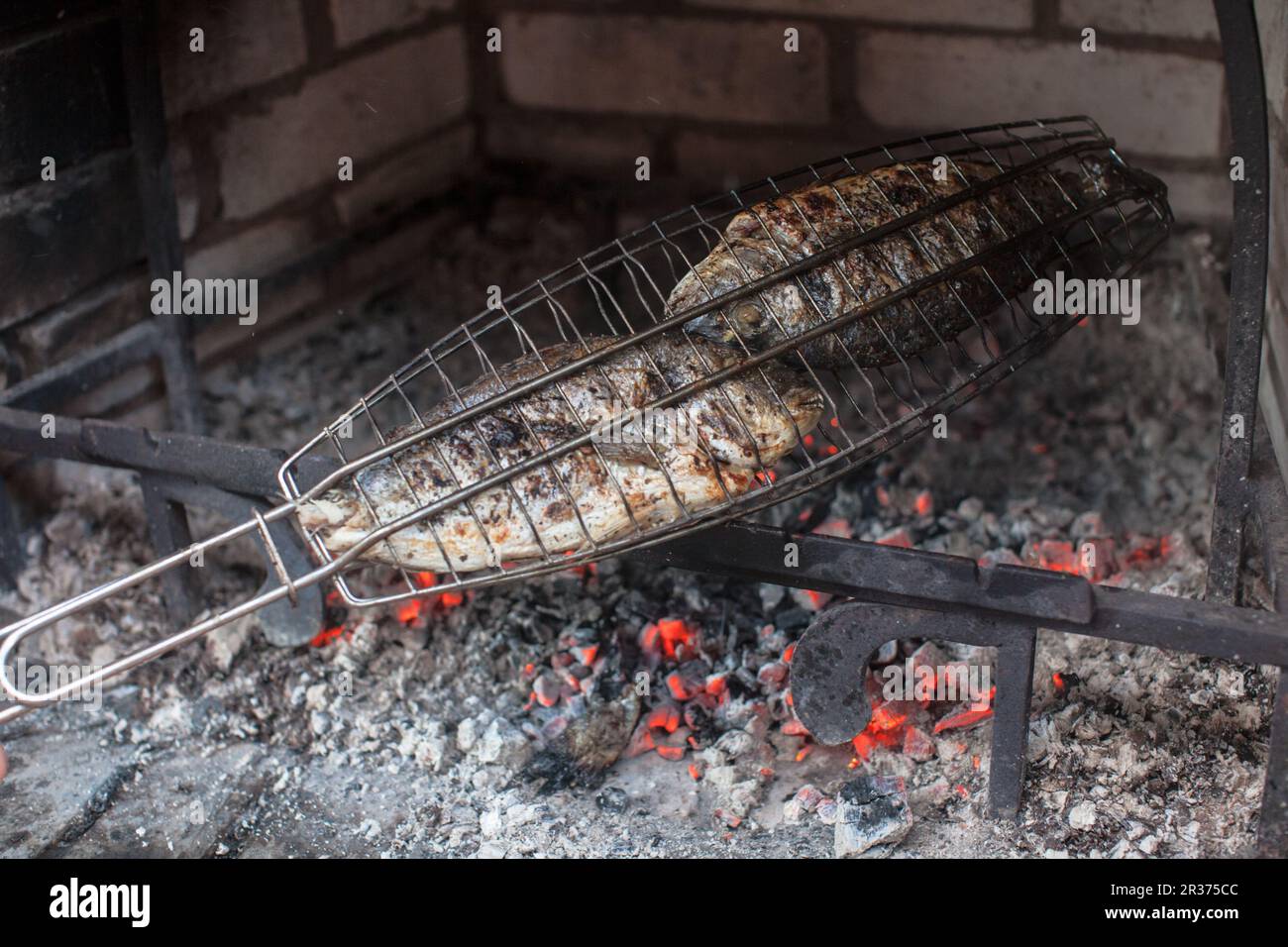 Cooking fish on a barbecue Stock Photo - Alamy
