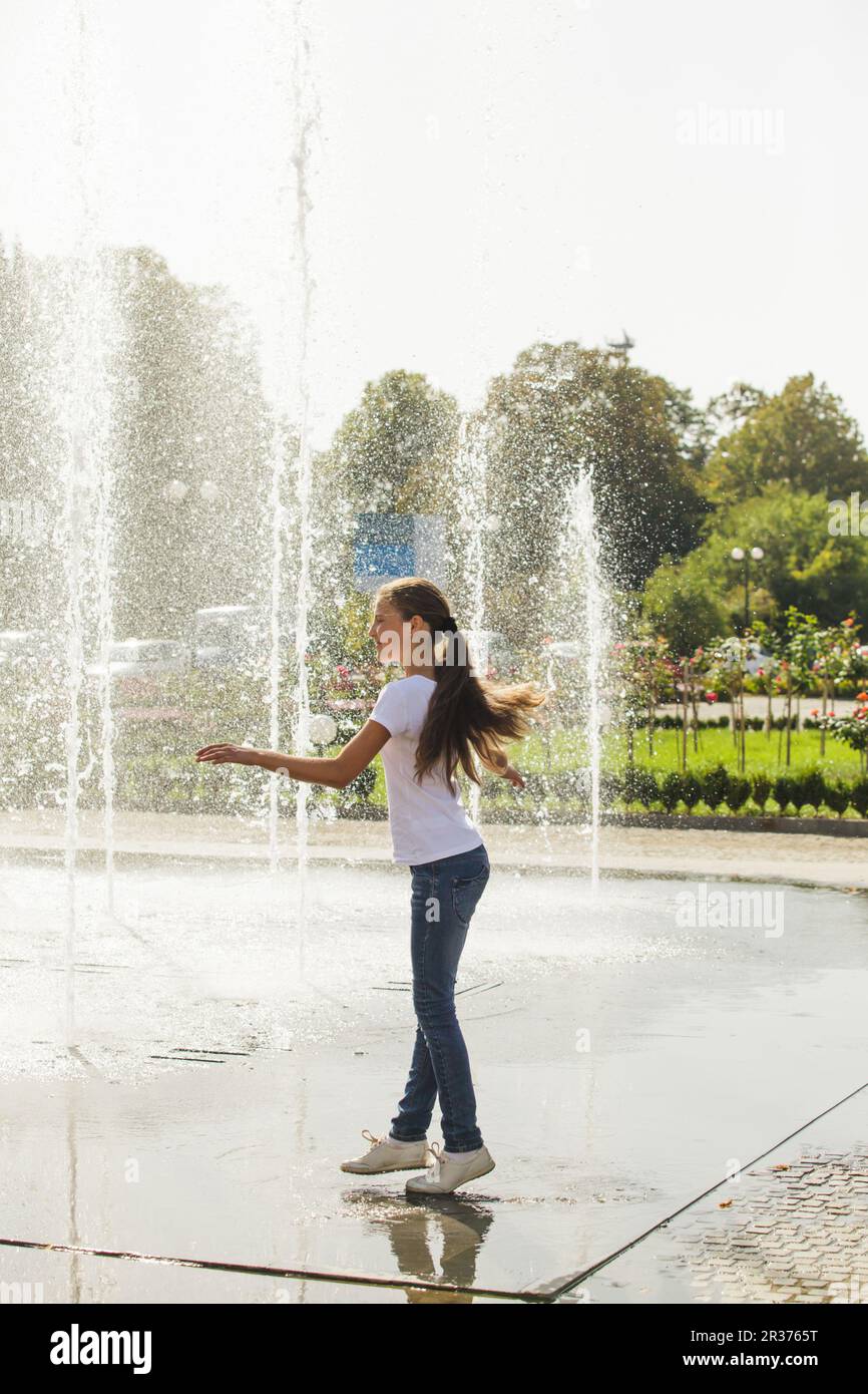 Two happy kids playing in fountain Stock Photo - Alamy