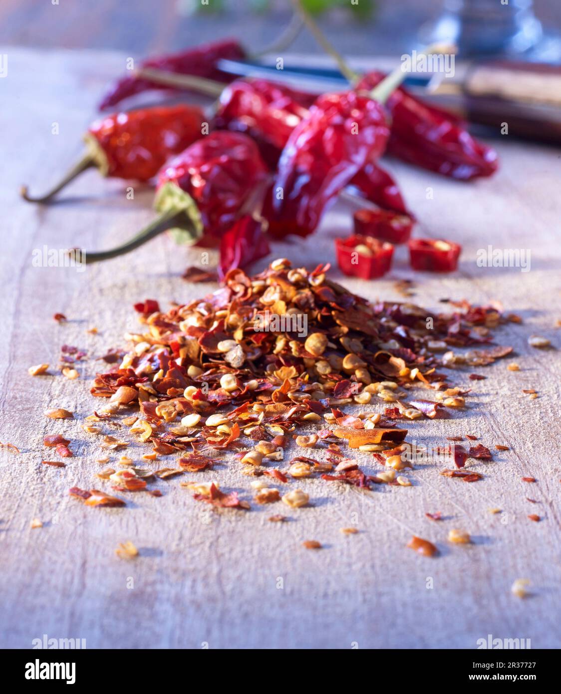 Crushed chillies on a wooden board Stock Photo