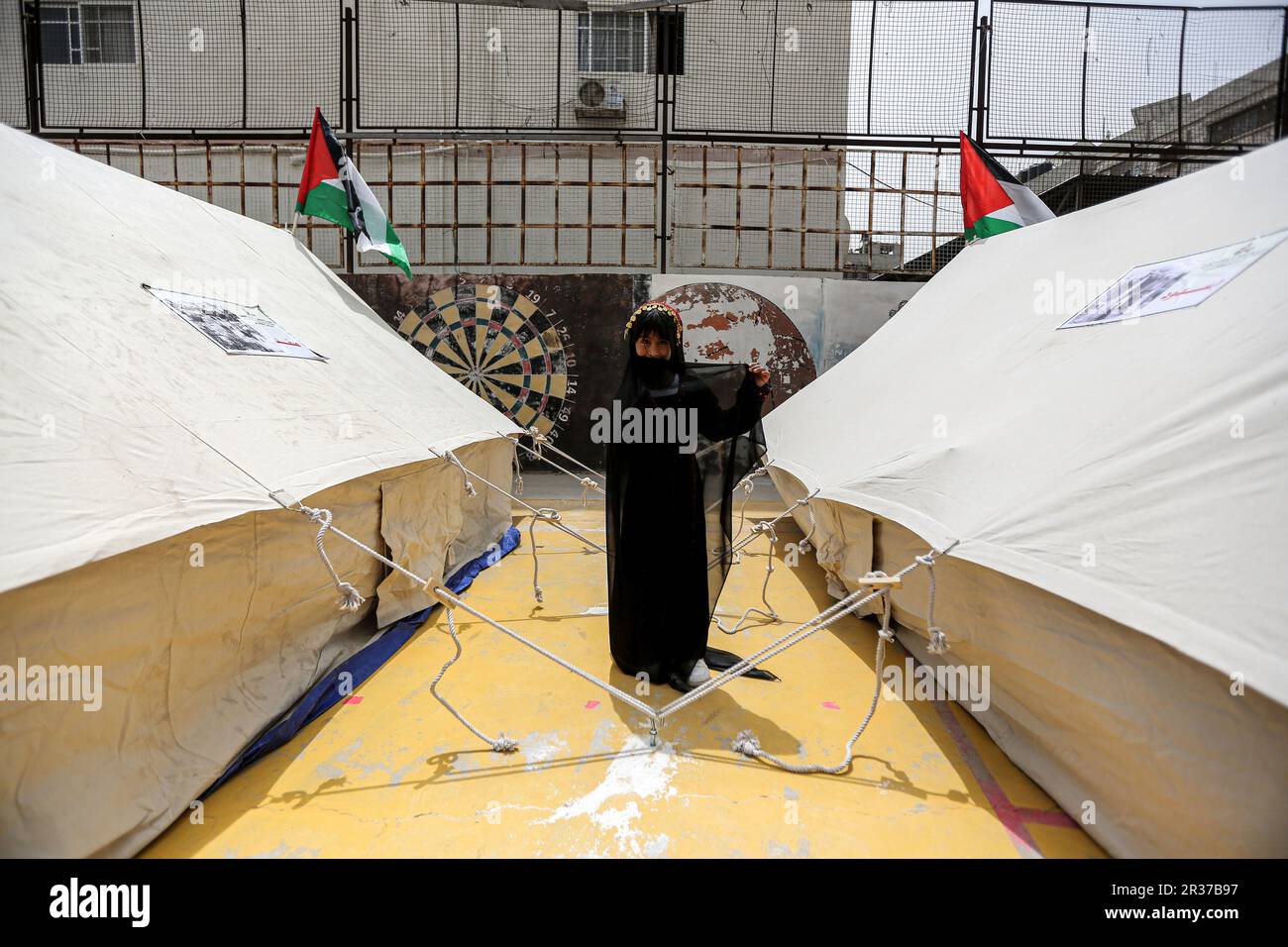 Gaza, Palestine. 22nd May, 2023. A Palestinian woman walks among ...