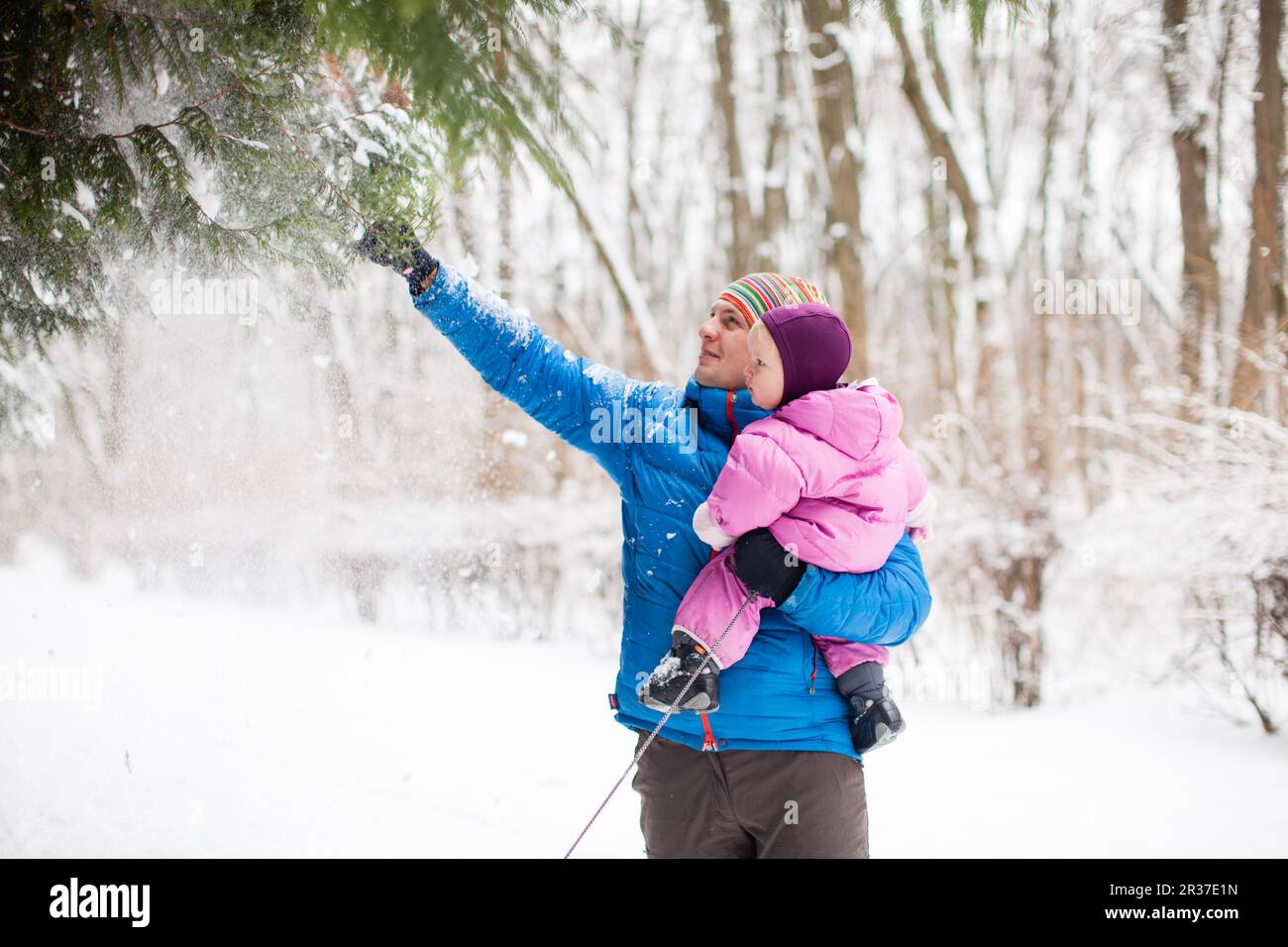 Father and daughter outdoors on winter snowy day Stock Photo