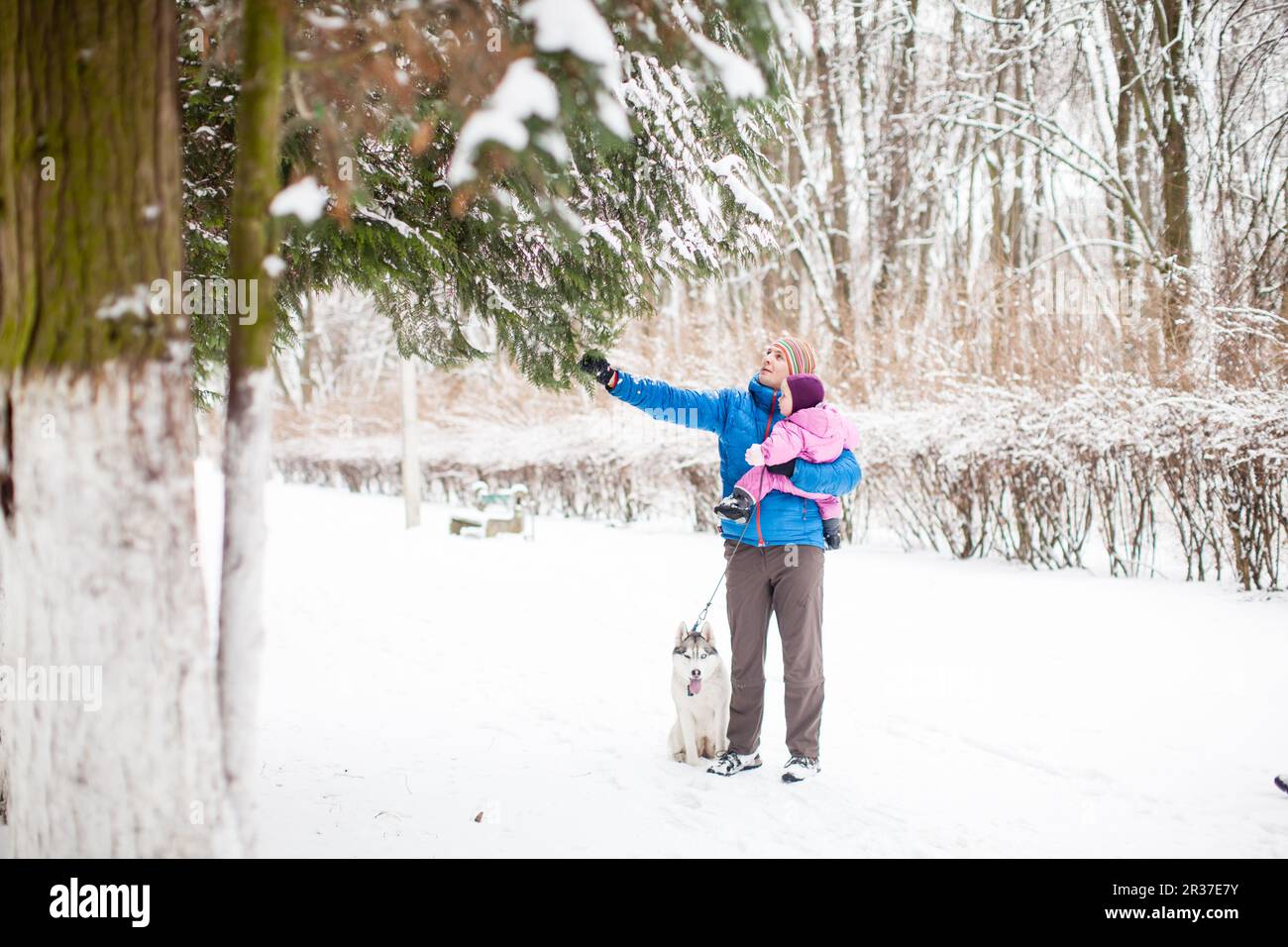 Father and daughter outdoors on winter snowy day Stock Photo