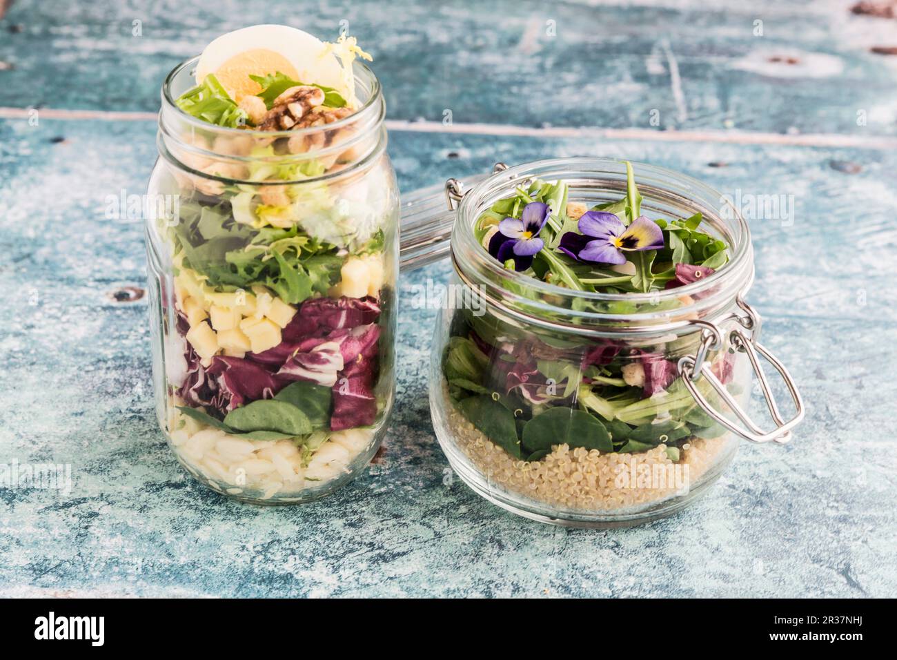 Orzo pasta salad and quinoa salad in glass jars Stock Photo