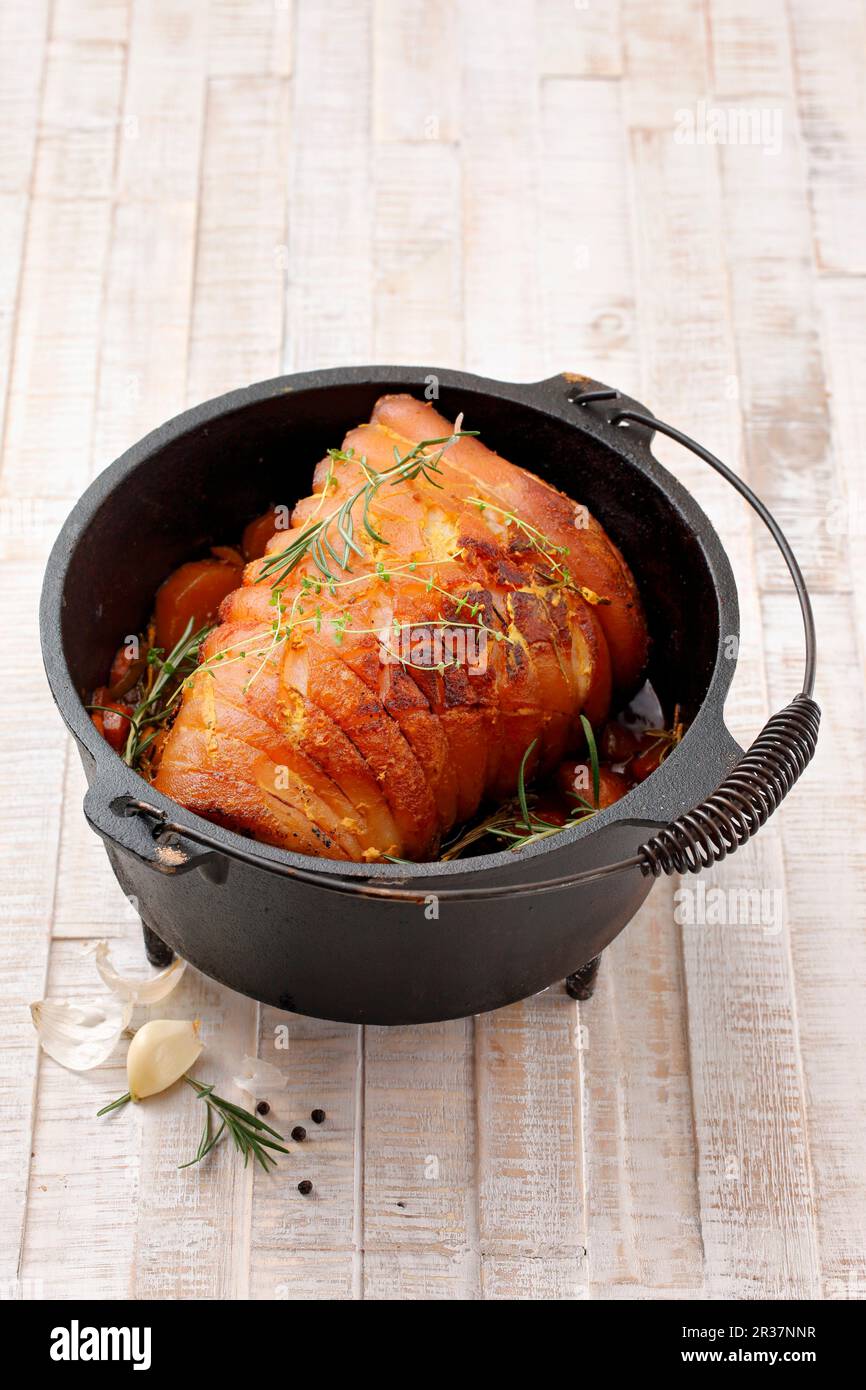 Rolled roasted pork belly in a Dutch oven cooking pot Stock Photo Alamy