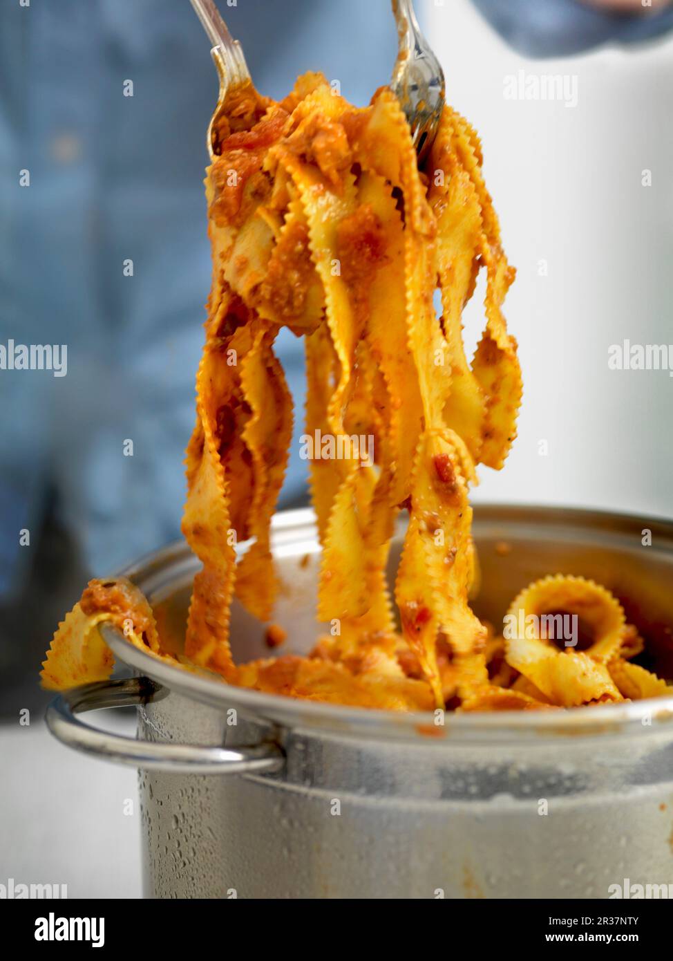 A serving of ribbon noodles with bolognese sauce Stock Photo Alamy