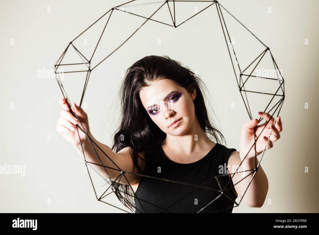 Female holding model of geometric solid Stock Photo