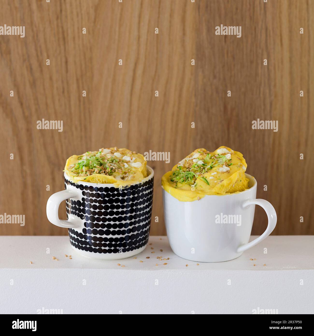 Savoury mug cakes with courgette, feta and sesame seeds Stock Photo