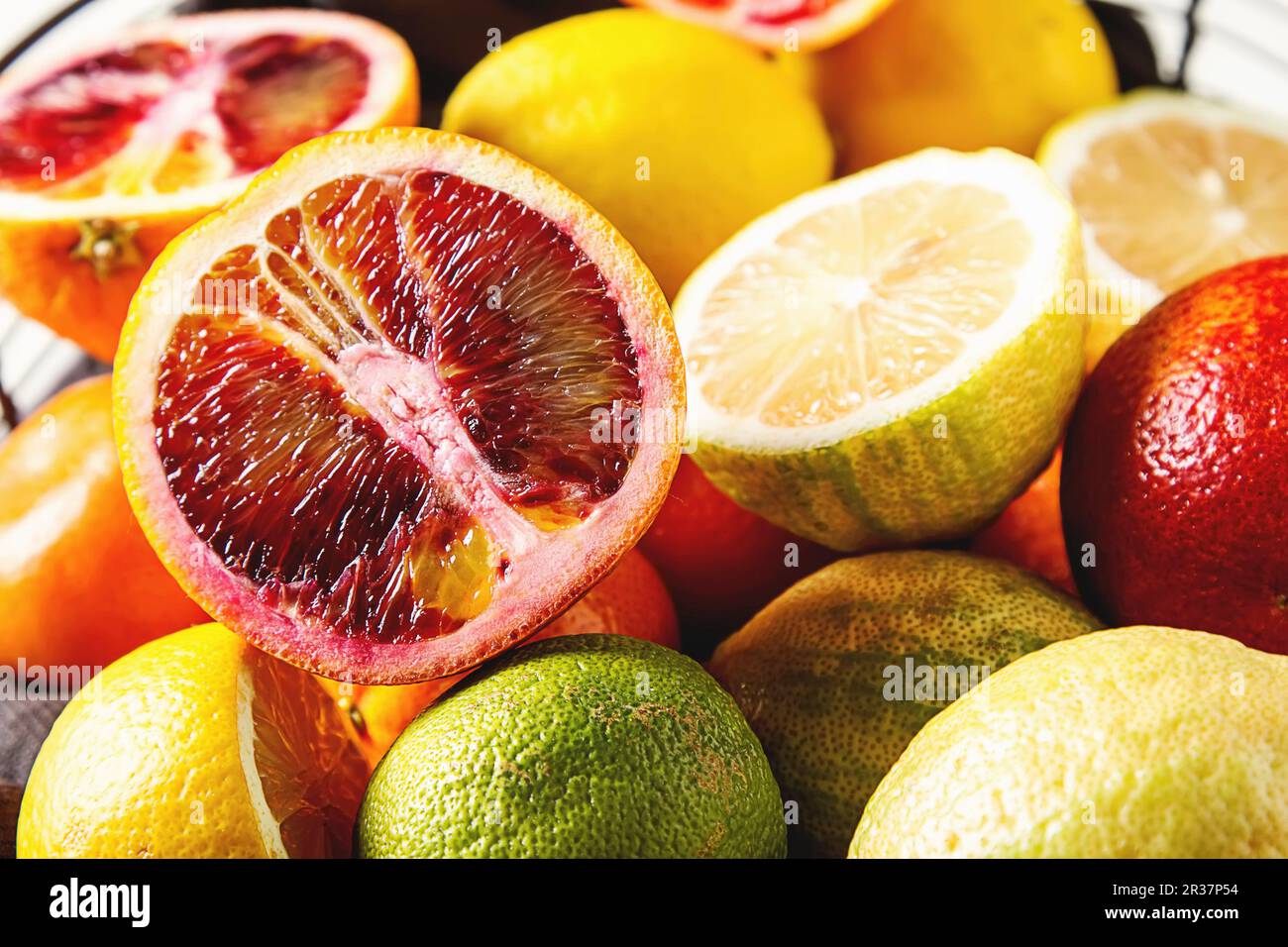 Various citrus fruit in a wire basket Stock Photo
