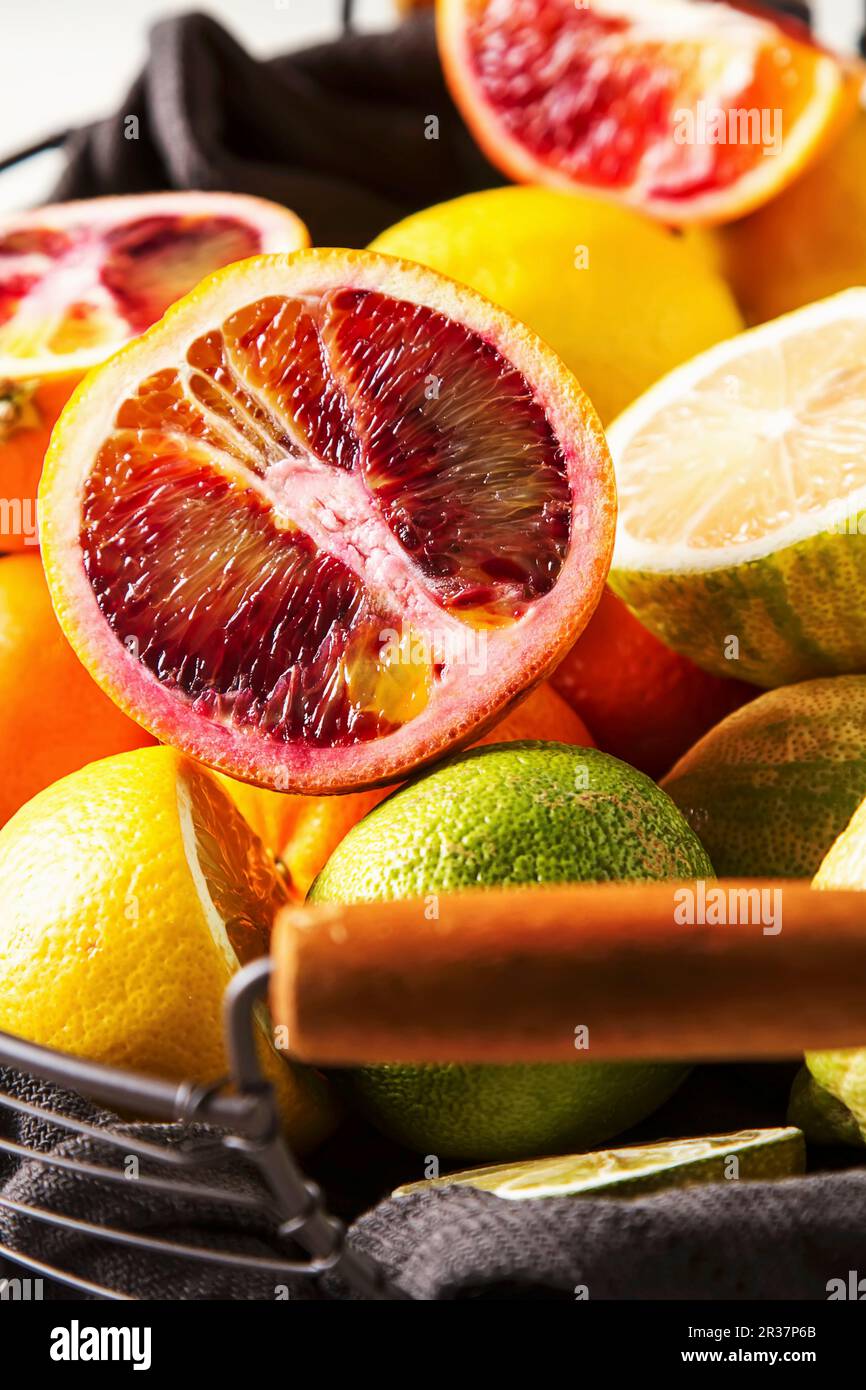 Various citrus fruit in a wire basket Stock Photo