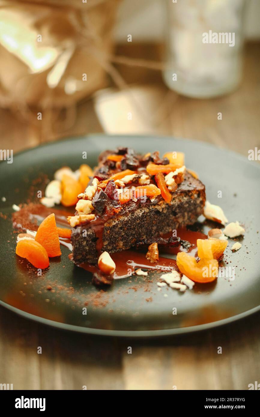 A slice of poppy seed tart with nuts and candied fruits Stock Photo