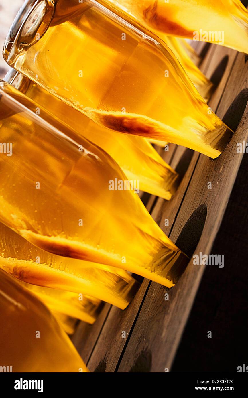 Sparkling wine bottles on a remuage rack Stock Photo