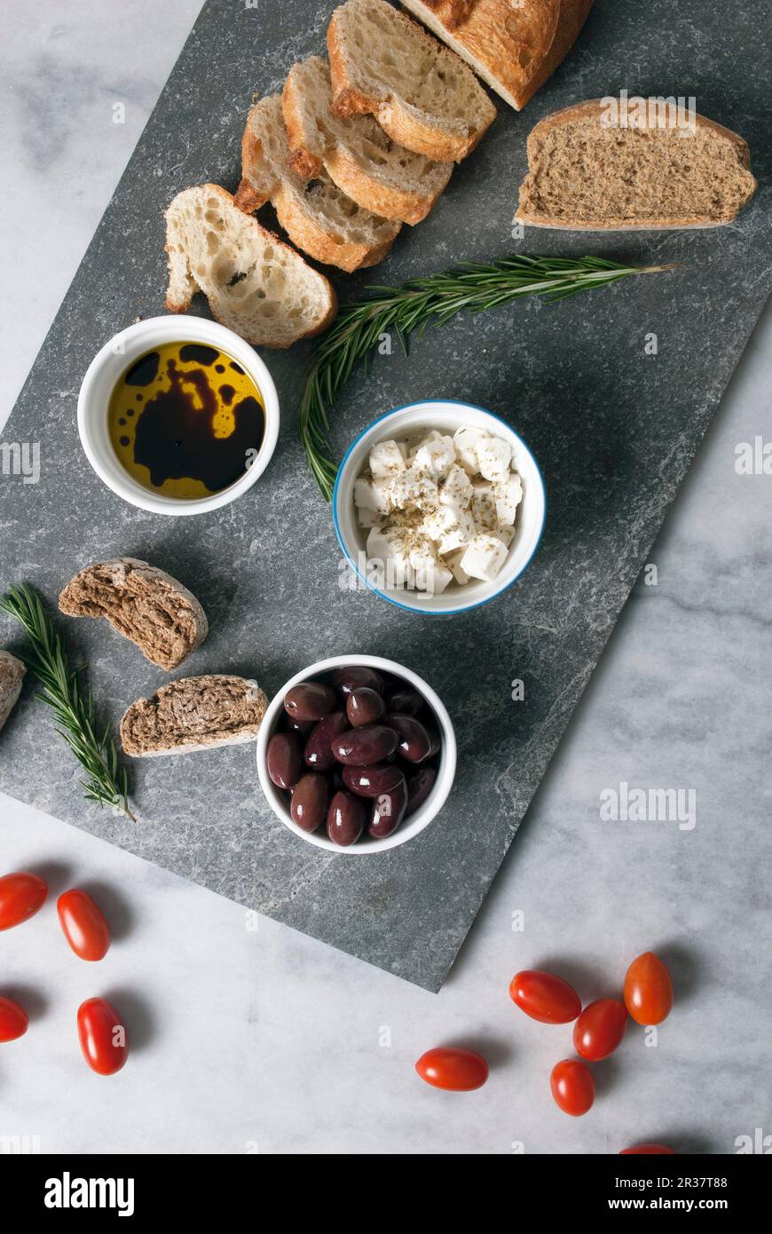 Greek mezze: olives, feta, olive oil and bread Stock Photo
