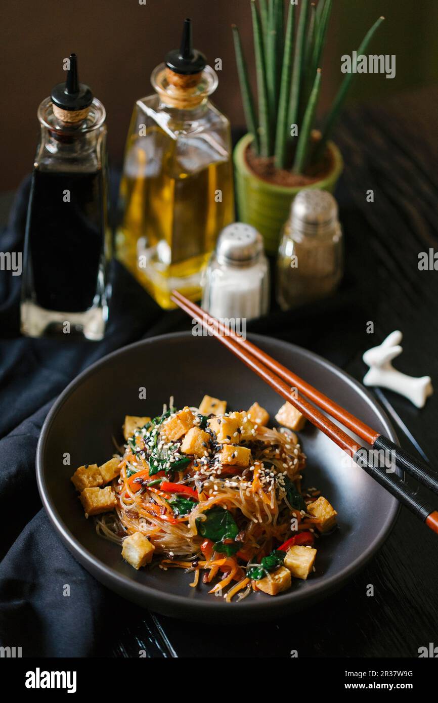 Glass noodles with vegetables, tofu and sesame Stock Photo