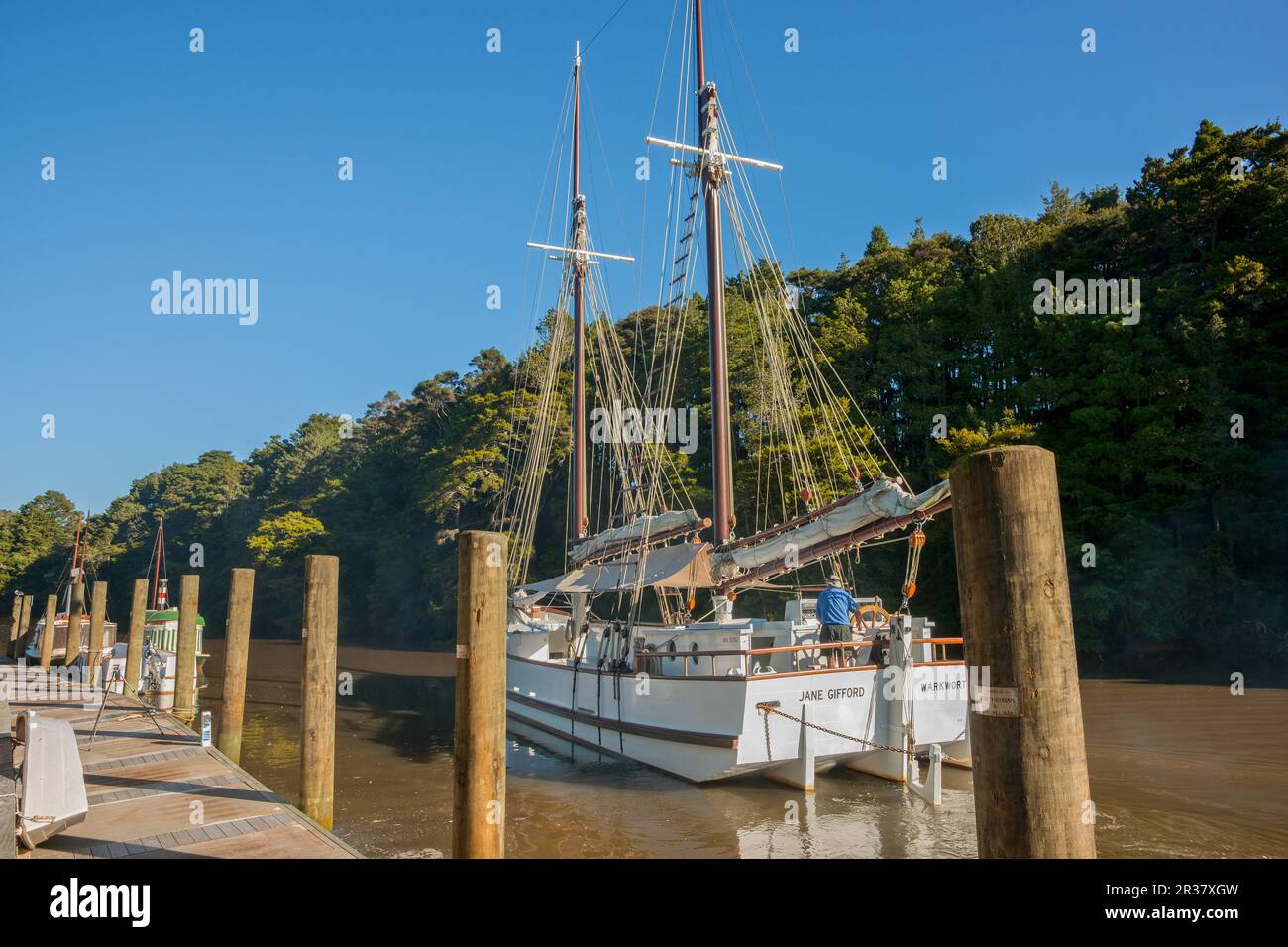 Warkworth New Zealand - March 8 2011; The Jane Gifford historic sailer leaving pier on Mahurangi River. Stock Photo