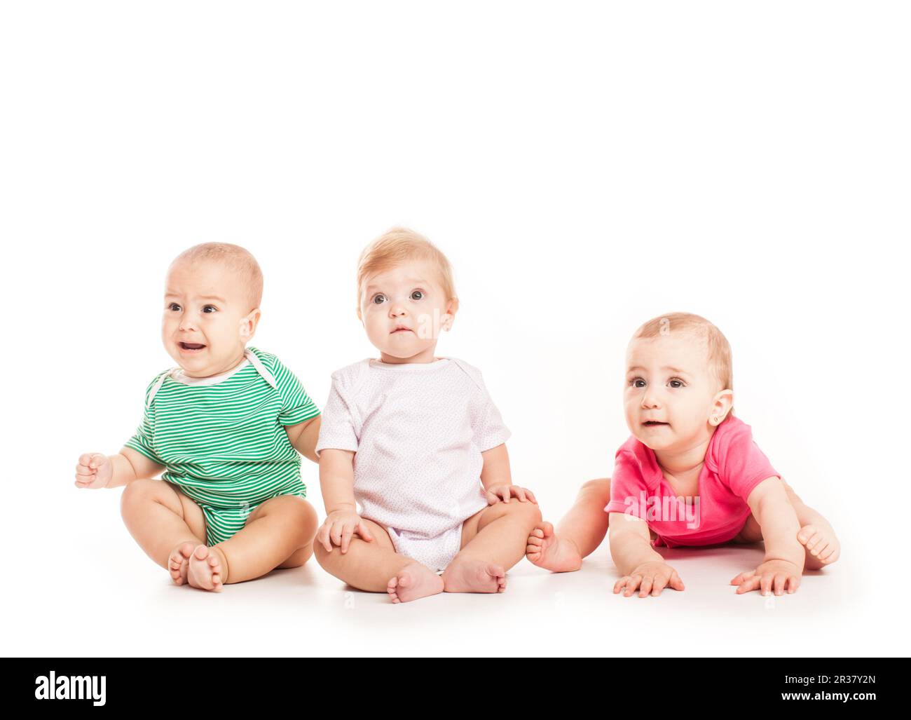 Three babies sitting Stock Photo - Alamy