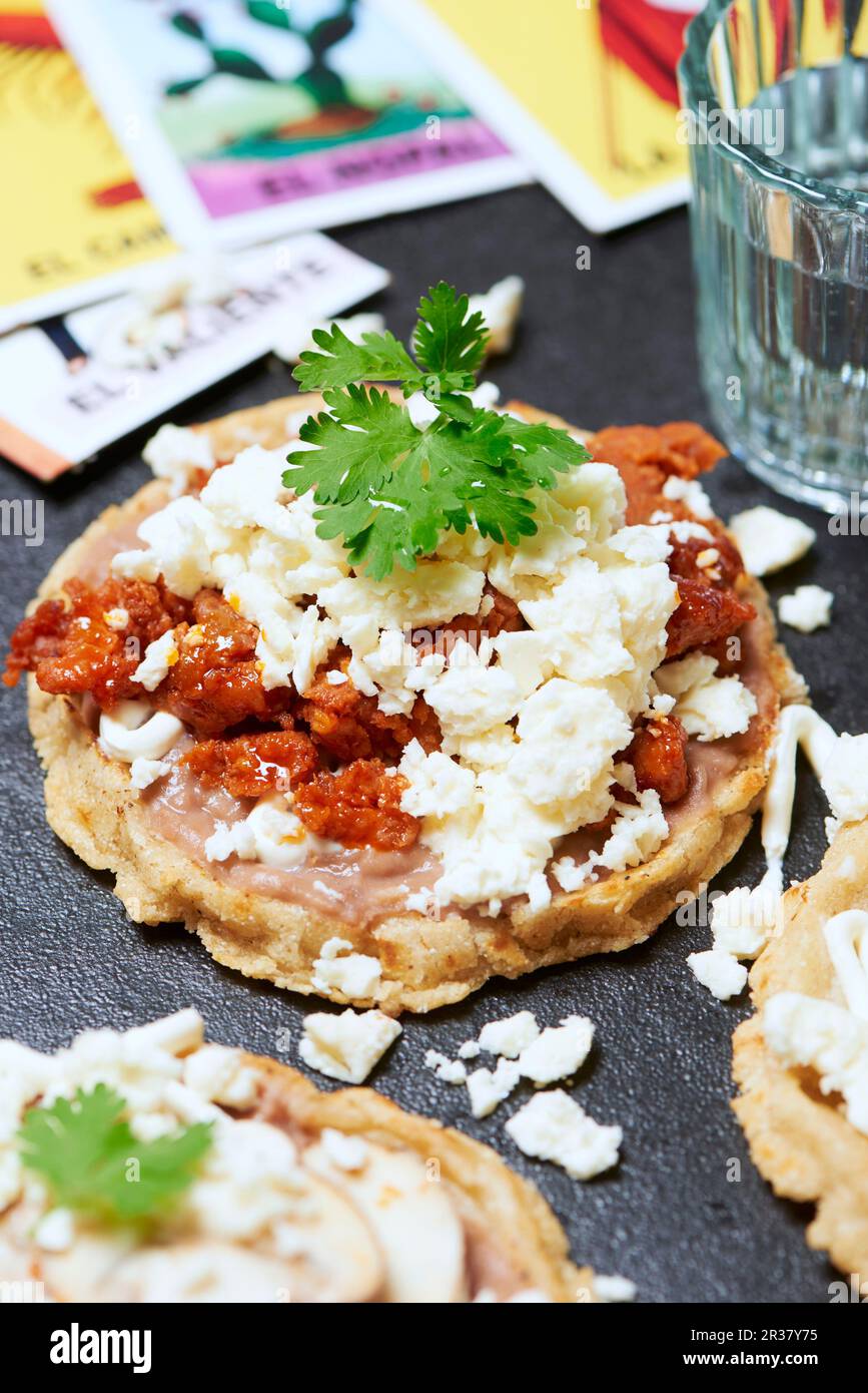 Sope, a traditional Mexican dish with bean purée, chorizo, cheese, sour