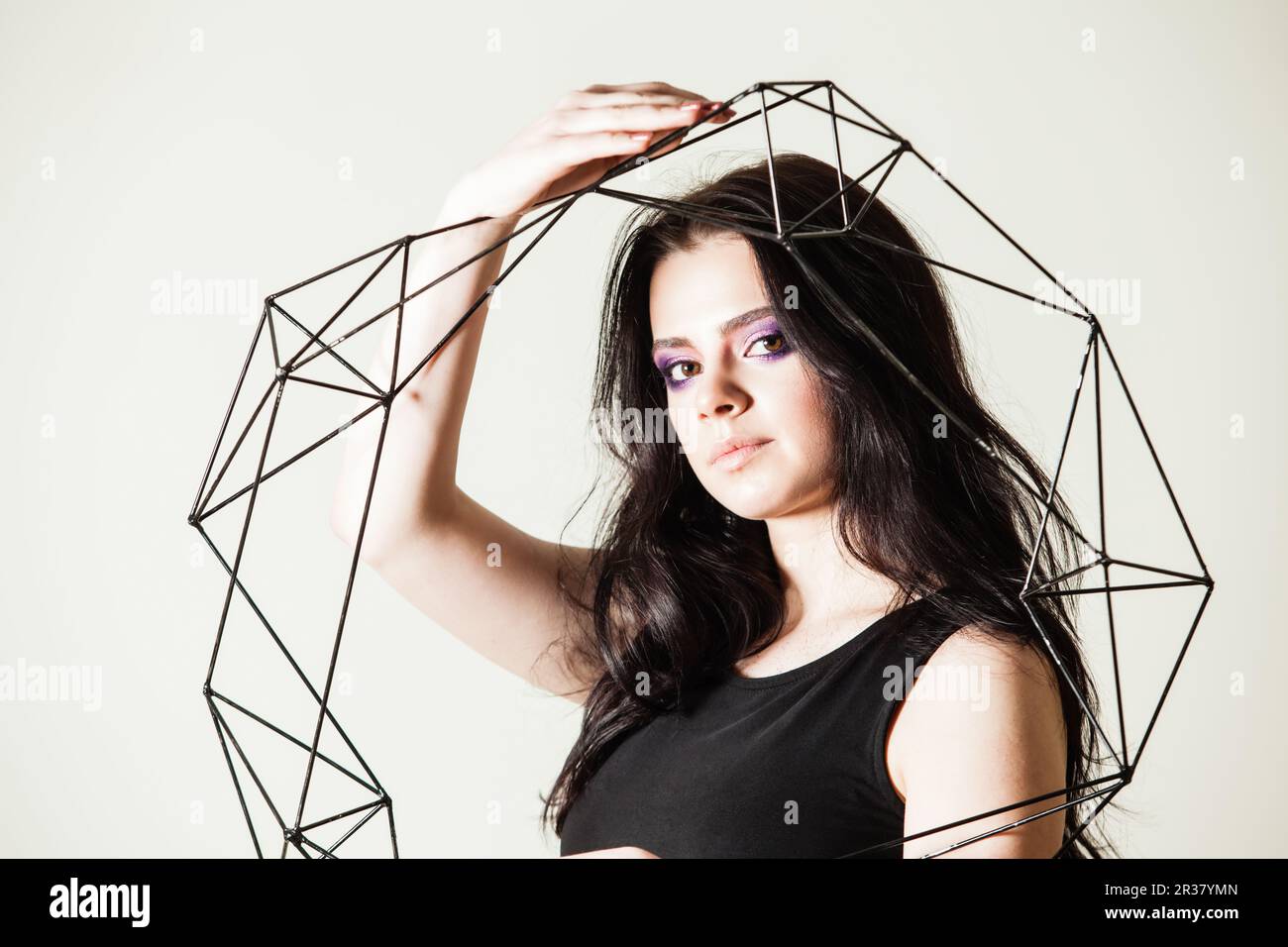 Female holding model of geometric solid Stock Photo