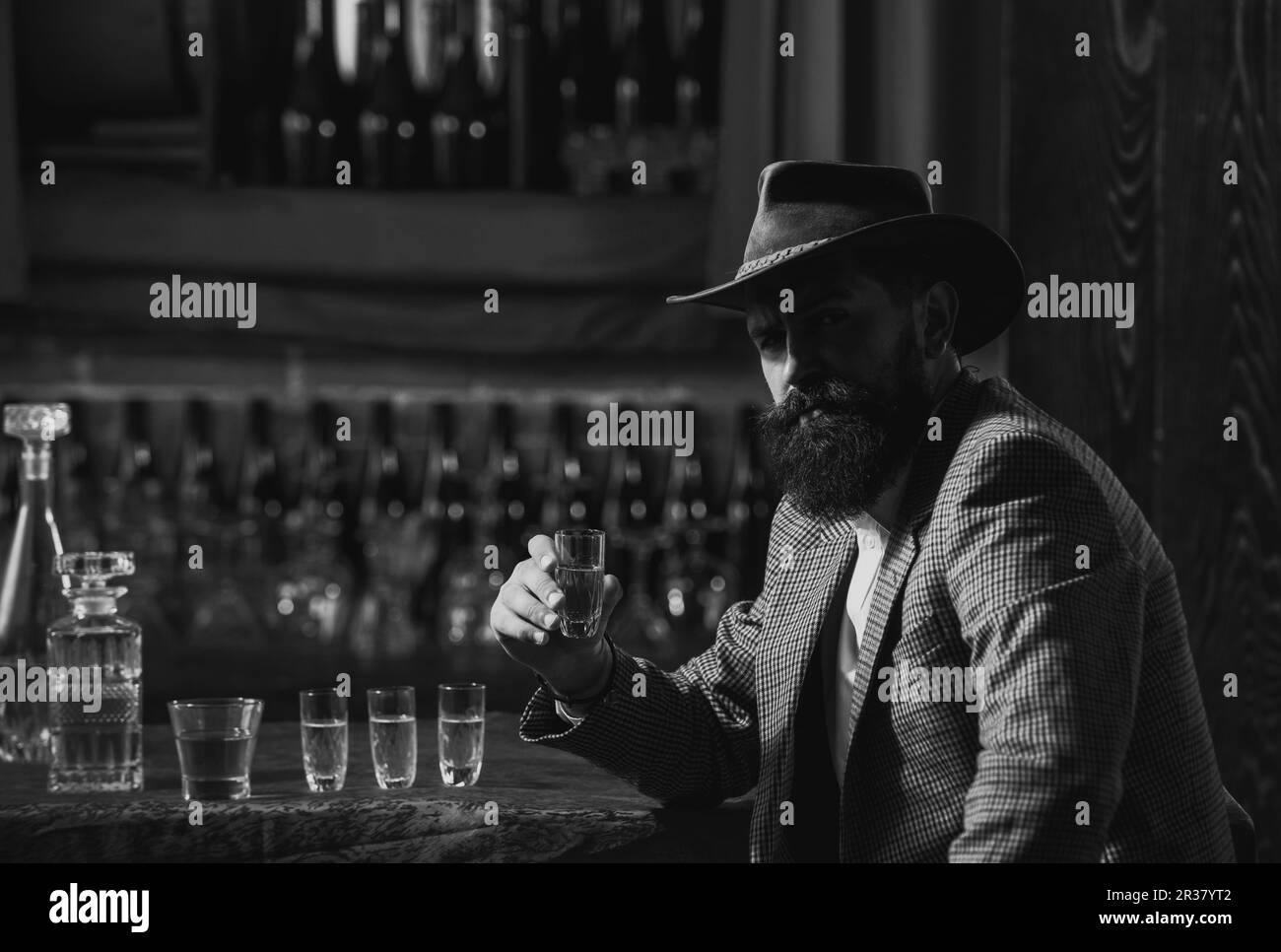 Bearded businessman in elegant suit with glass of whiskey. Stock Photo