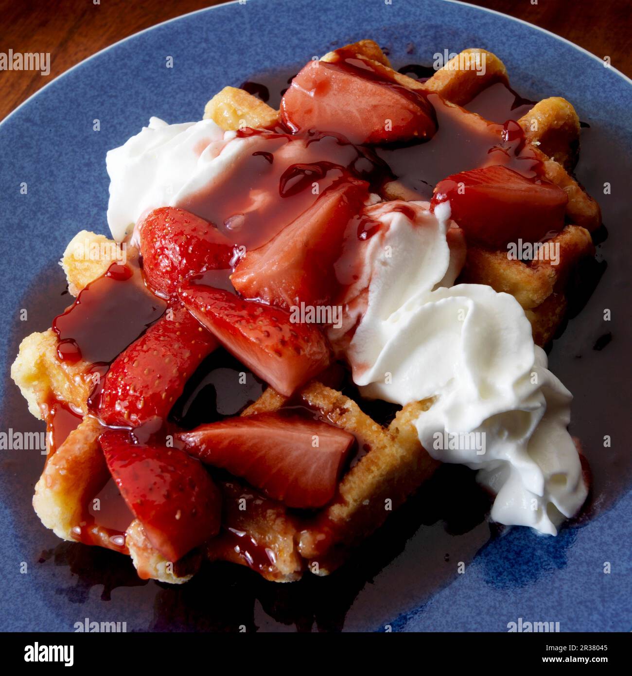 Belgian waffle with whipped cream and strawberry compote Stock Photo ...