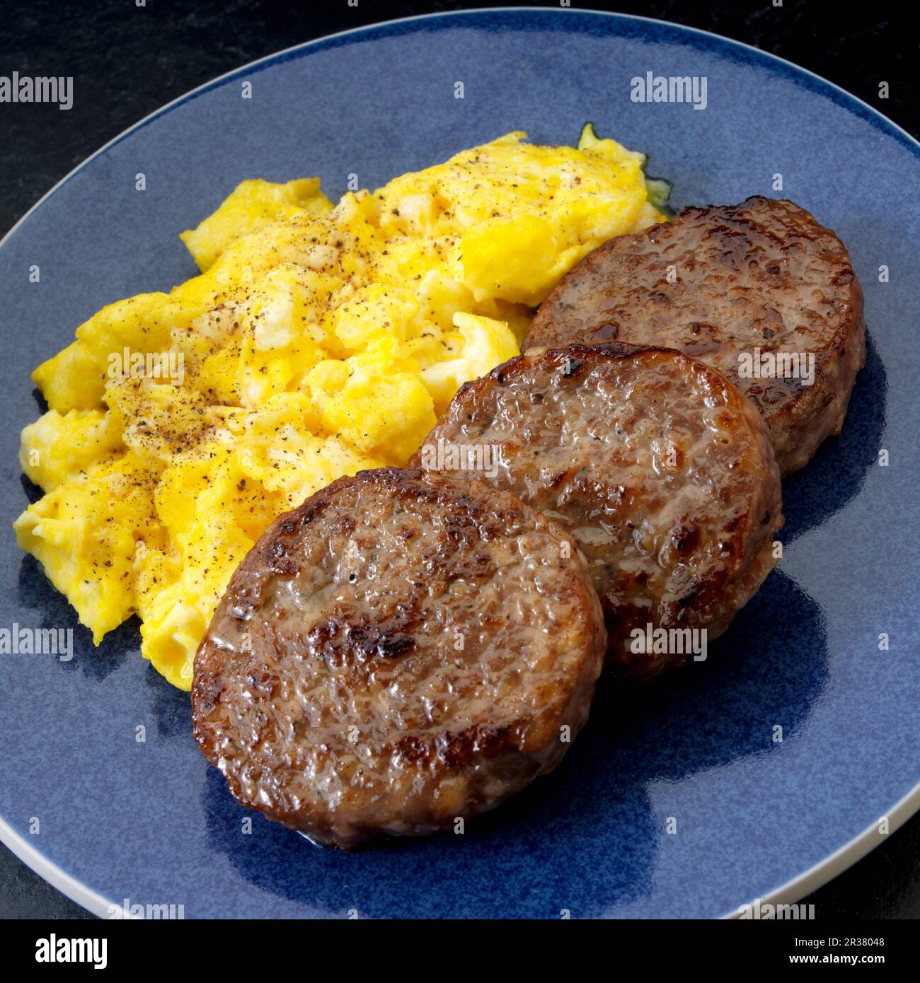 Pork sausage patties with scrambled eggs Stock Photo Alamy