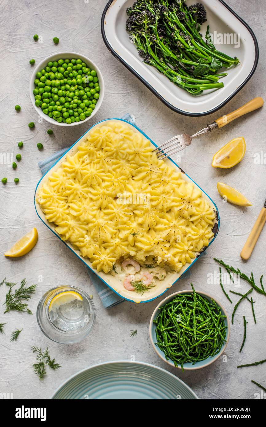 Fish pie with vegetable side dishes Stock Photo