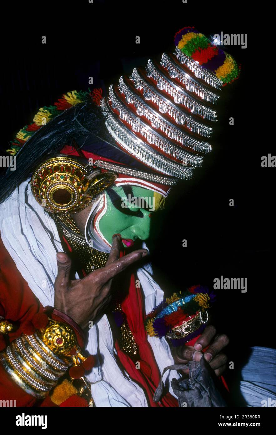 A Katakali artist applying makeup, very elaborate process in Kerala