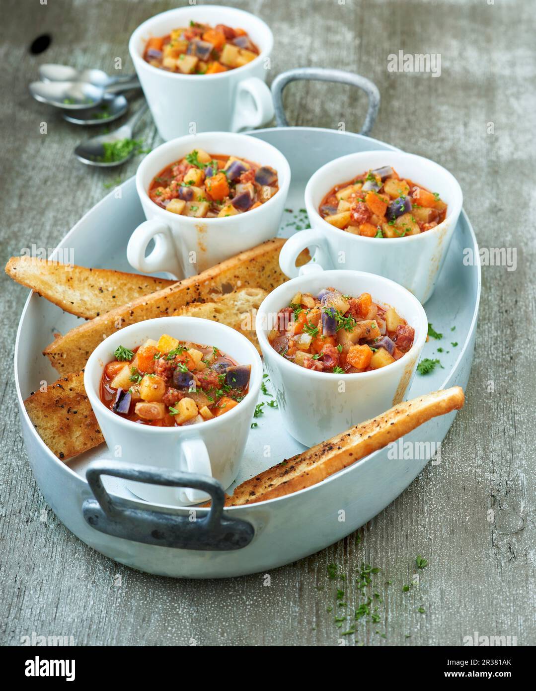Colourful potato pots with chorizo and spicy toast Stock Photo