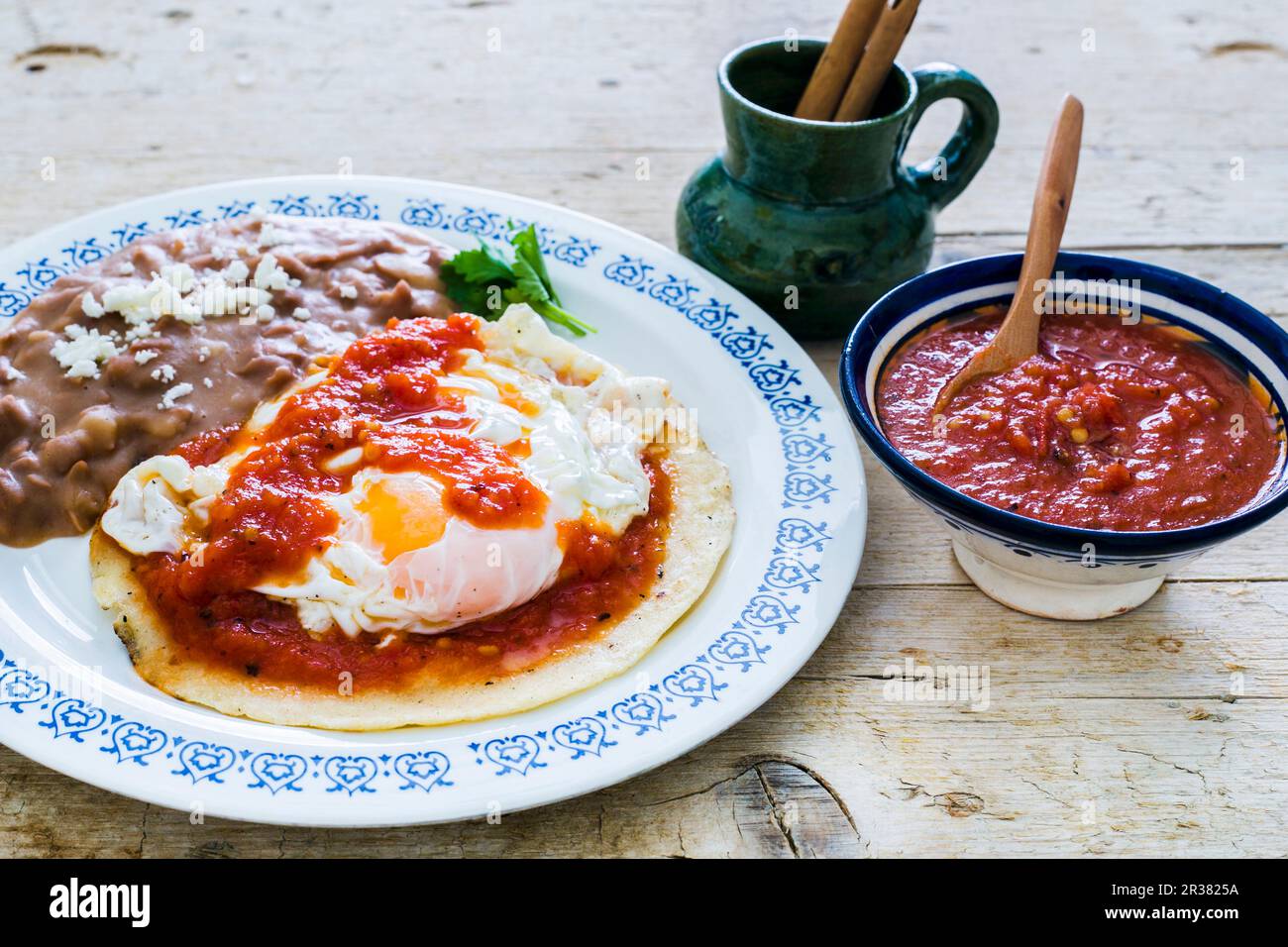 Huevos Rancheros (fried eggs on a corn tortilla with roasted beans and tomato sauce, Mexico) Stock Photo