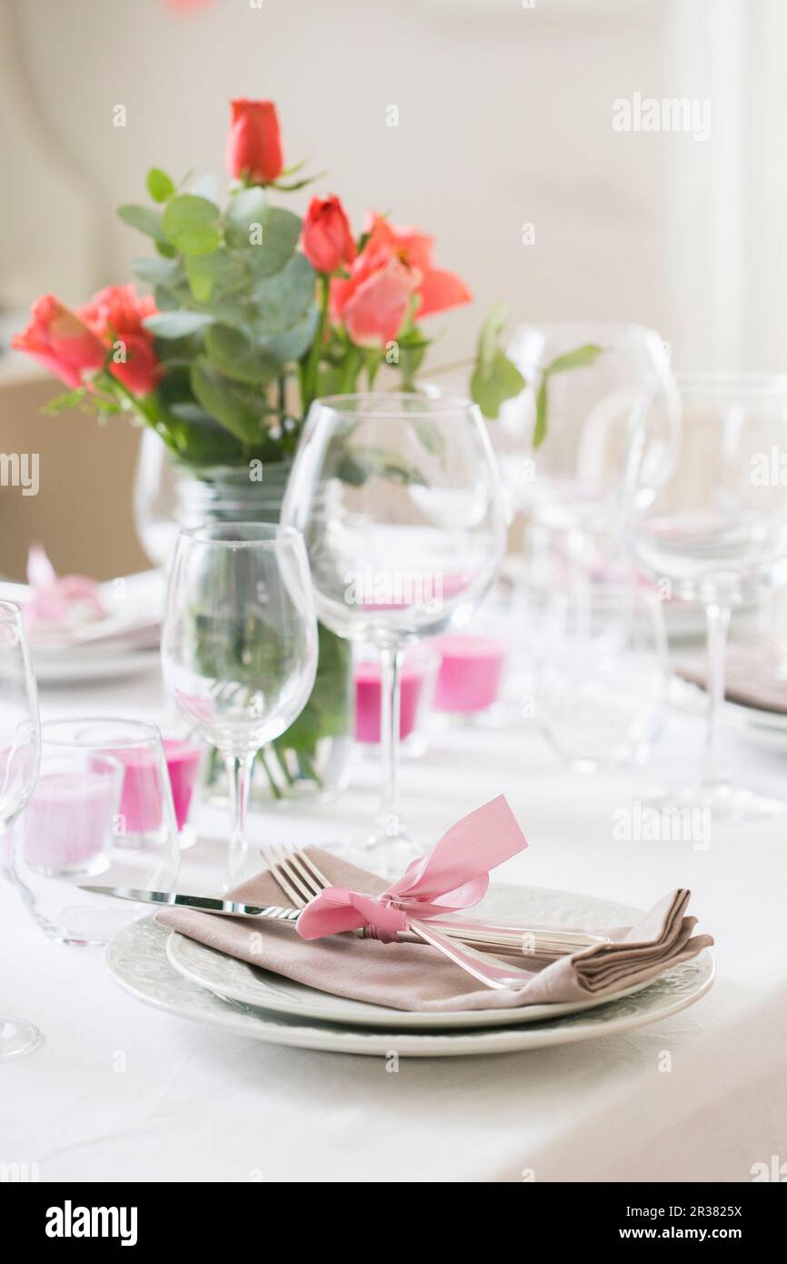 A table set with roses and candles Stock Photo