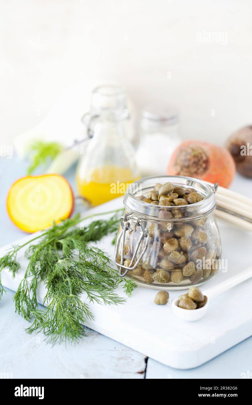 A jar of capers with dill Stock Photo Alamy