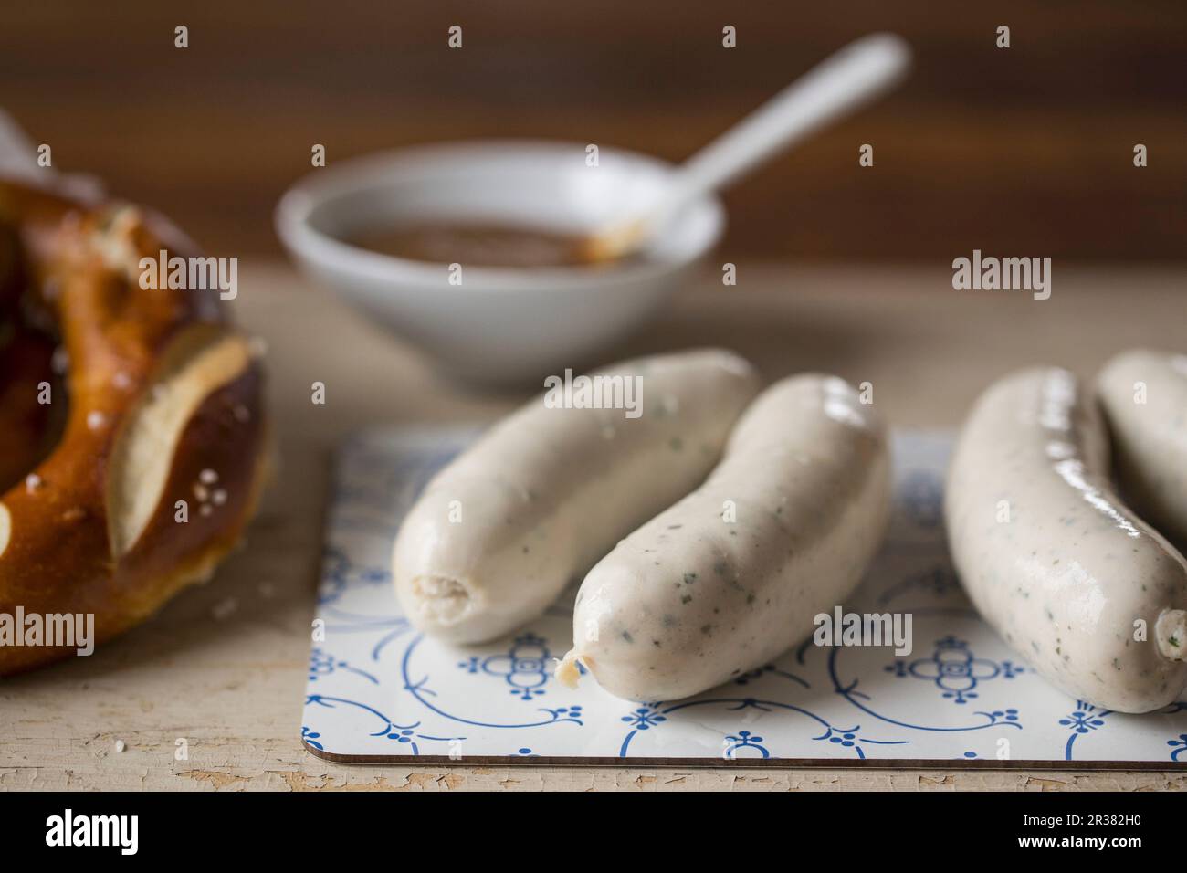 Weisswurst (white sausage) with pretzel and mild mustard Stock Photo