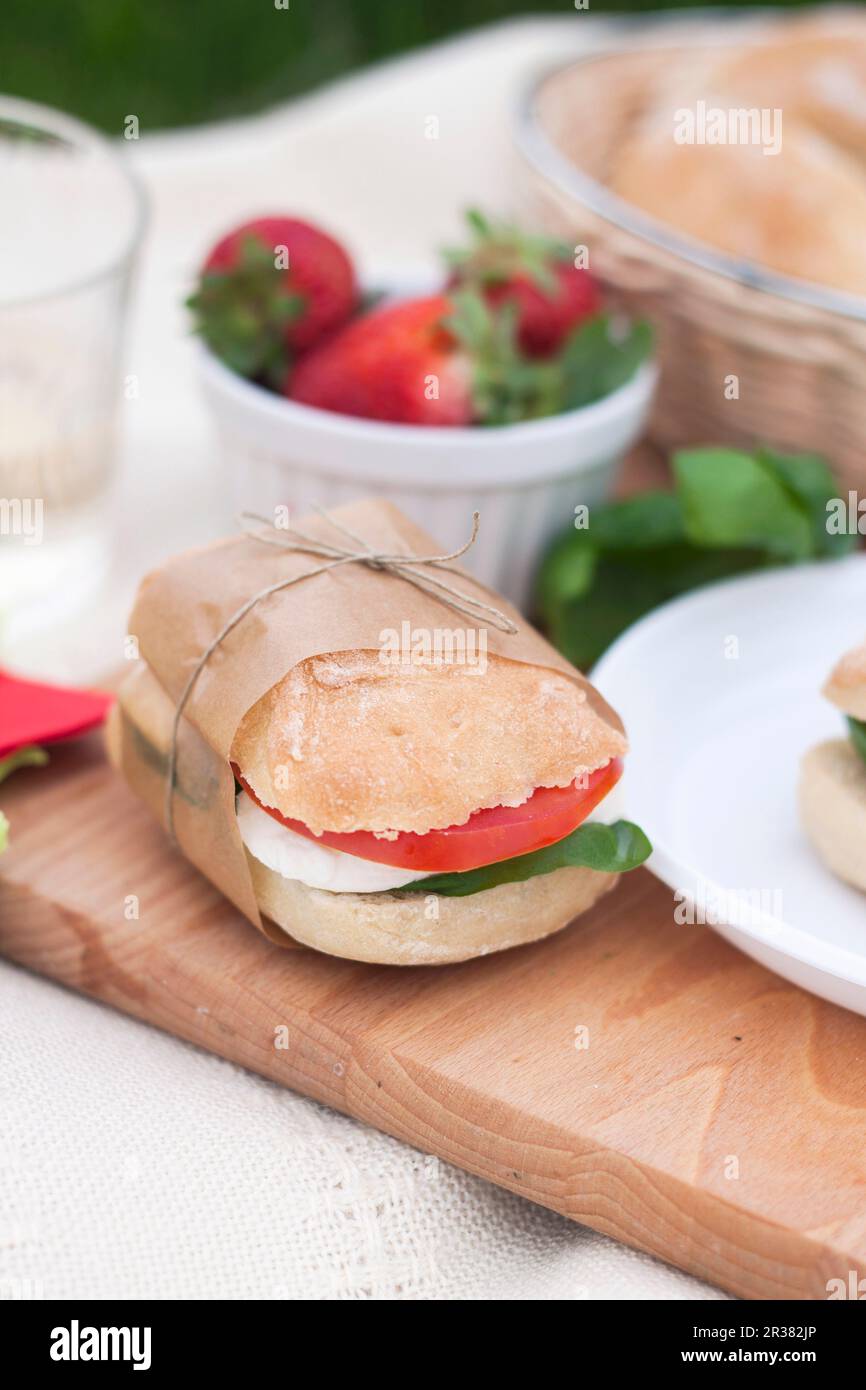 A caprese sandwich with ciabatta, mozzarella, tomato and basil Stock
