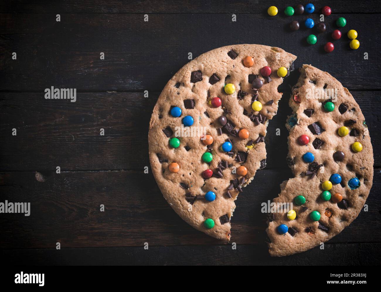 A huge chocolate chip cookie with colourful sugarcoated chocolate