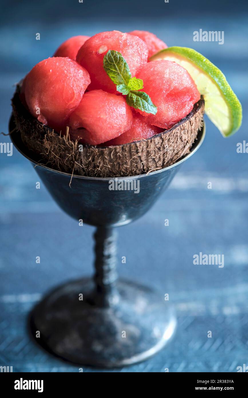 Watermelon balls in a coconut shell and ice cream dish Stock Photo
