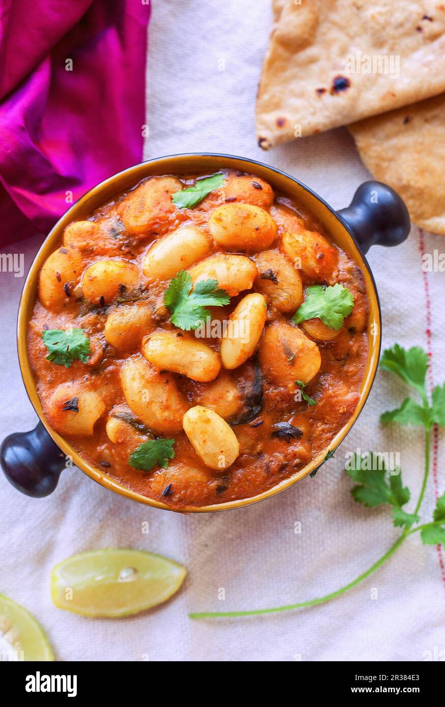 Lima bean and tomato curry with coriander Stock Photo Alamy