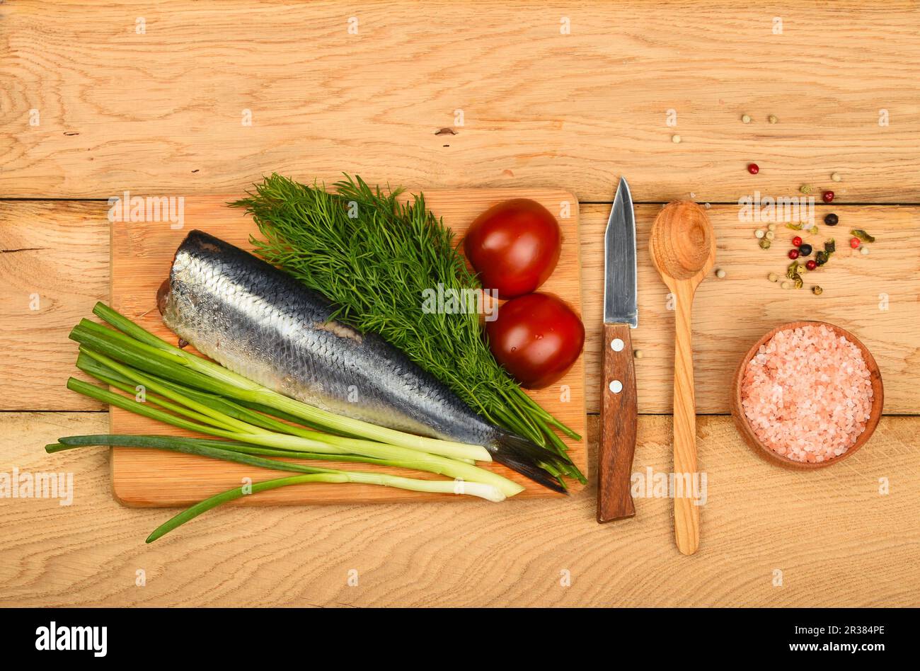 Herring double fillet with onion, dill and tomatoes on bamboo board win