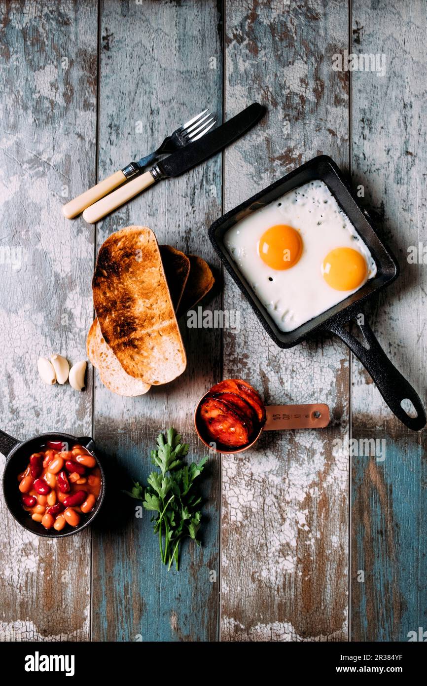 Breakfast with mixed beans, sourdough toast, eggs, chorizo, garlic and