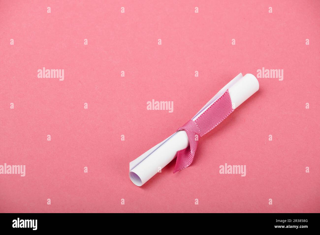 One white paper scroll message on pink background Stock Photo - Alamy