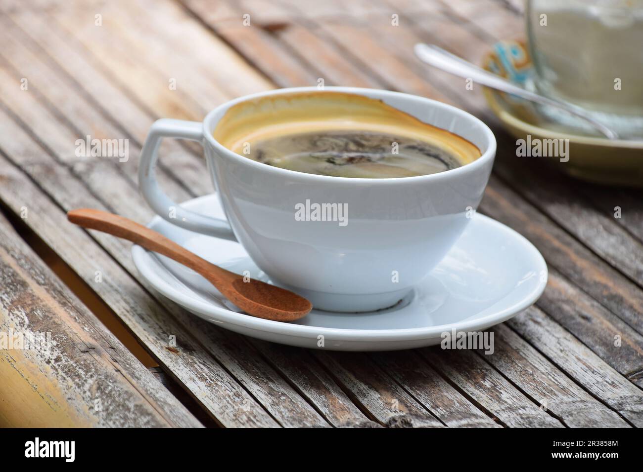 One full cup of Americano coffee on bamboo table Stock Photo