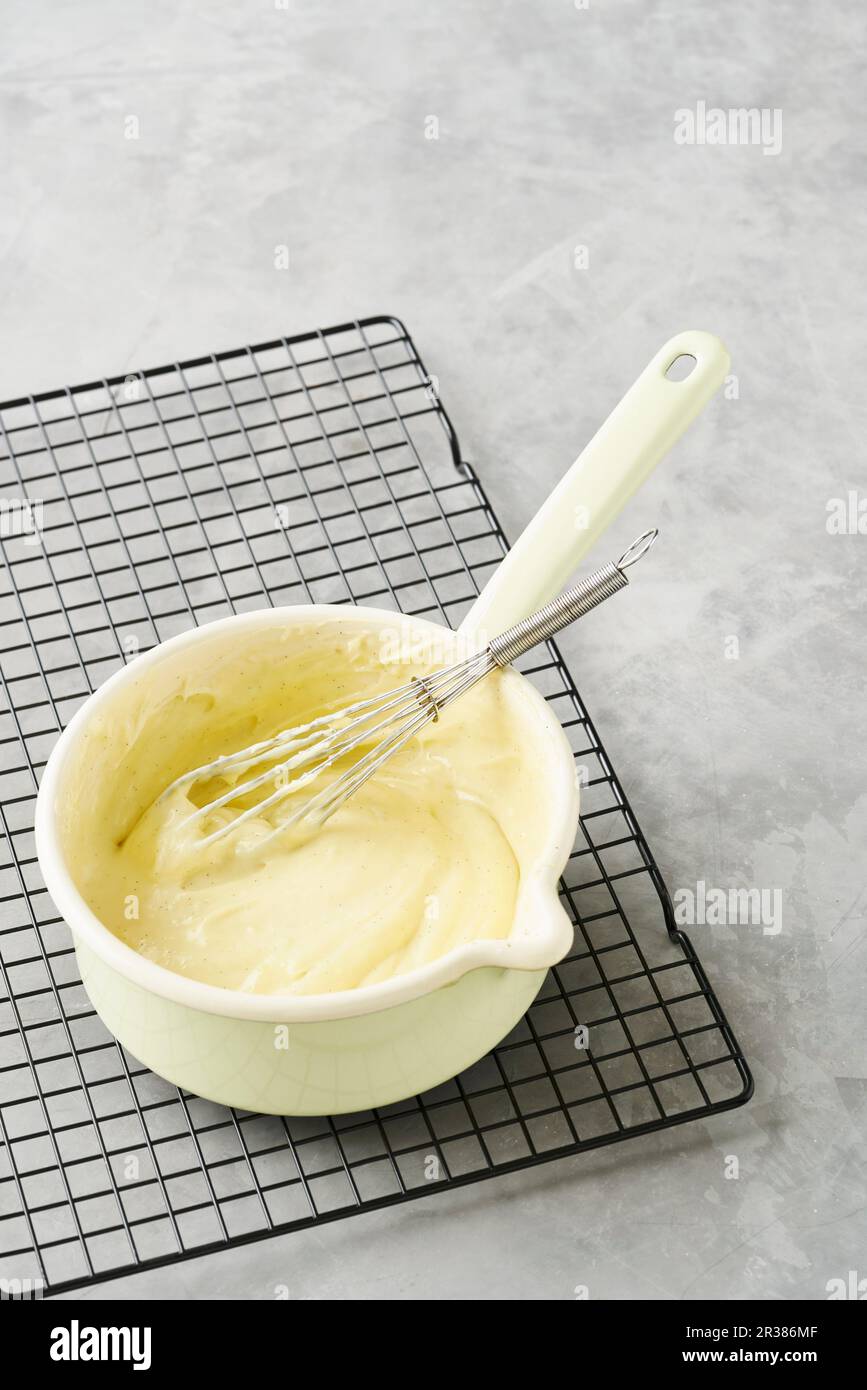 Whipped vanilla cream in an enamel pot Stock Photo