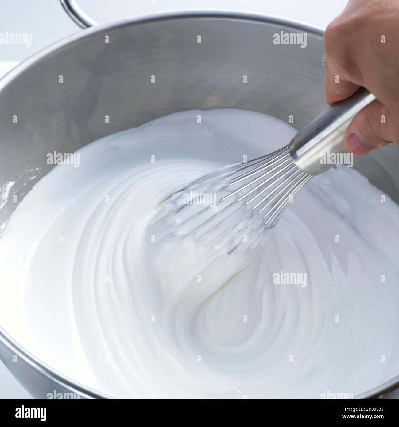 Beating egg whites with a whisk Stock Photo