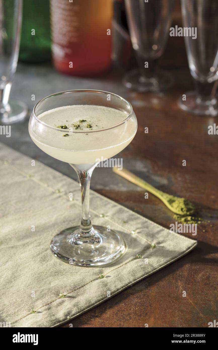 Sesame ginger vodka cocktail, garnished with matcha powder Stock Photo ...