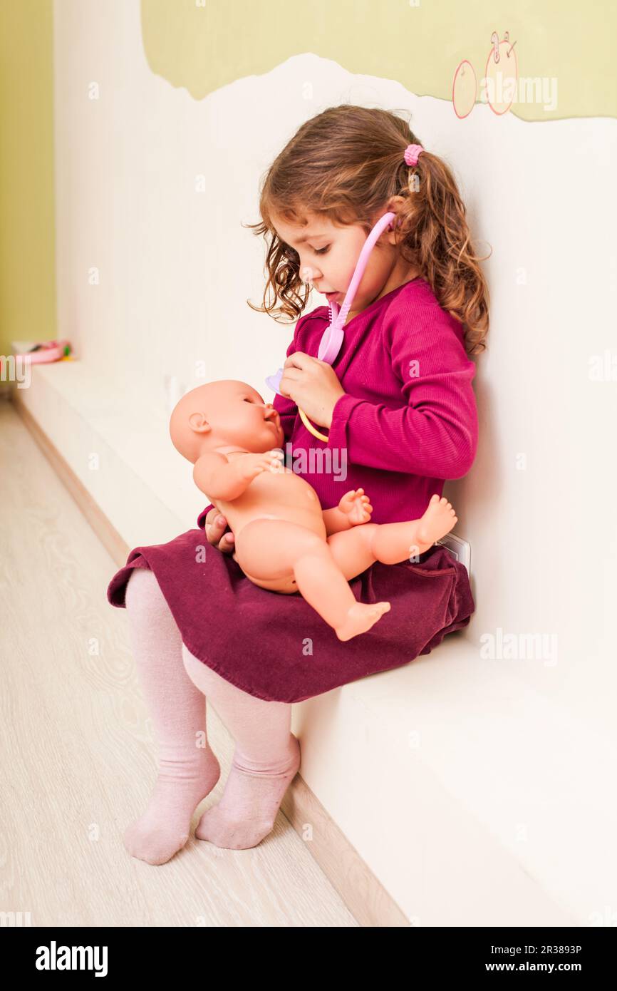 Girl plays the doctor Stock Photo