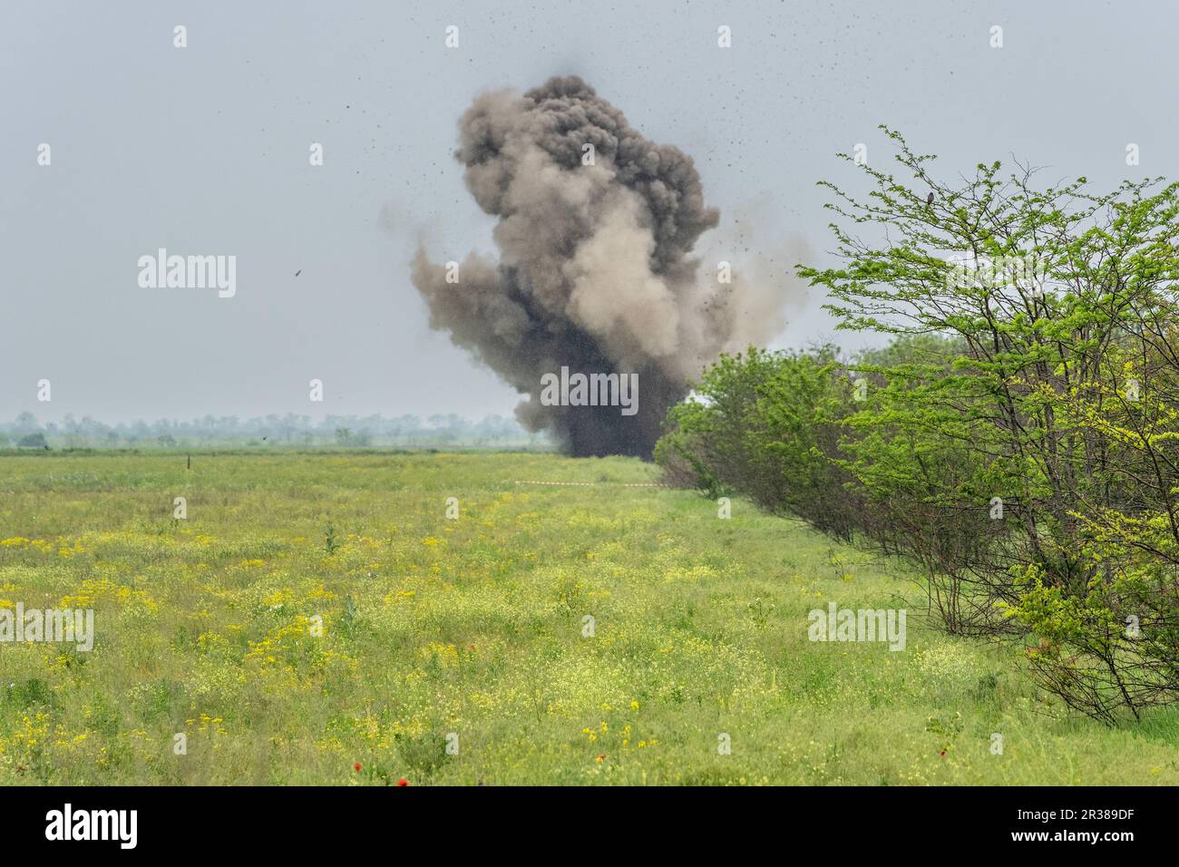 Controlled explosion of unexploded munition collected by de-mining unit of National Guards of Ukraine seen in near Kherson in Ukraine on May 22, 2023 Stock Photo