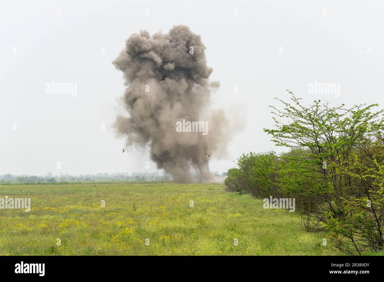 Controlled explosion of unexploded munition collected by de-mining unit of National Guards of Ukraine seen in near Kherson in Ukraine on May 22, 2023 Stock Photo