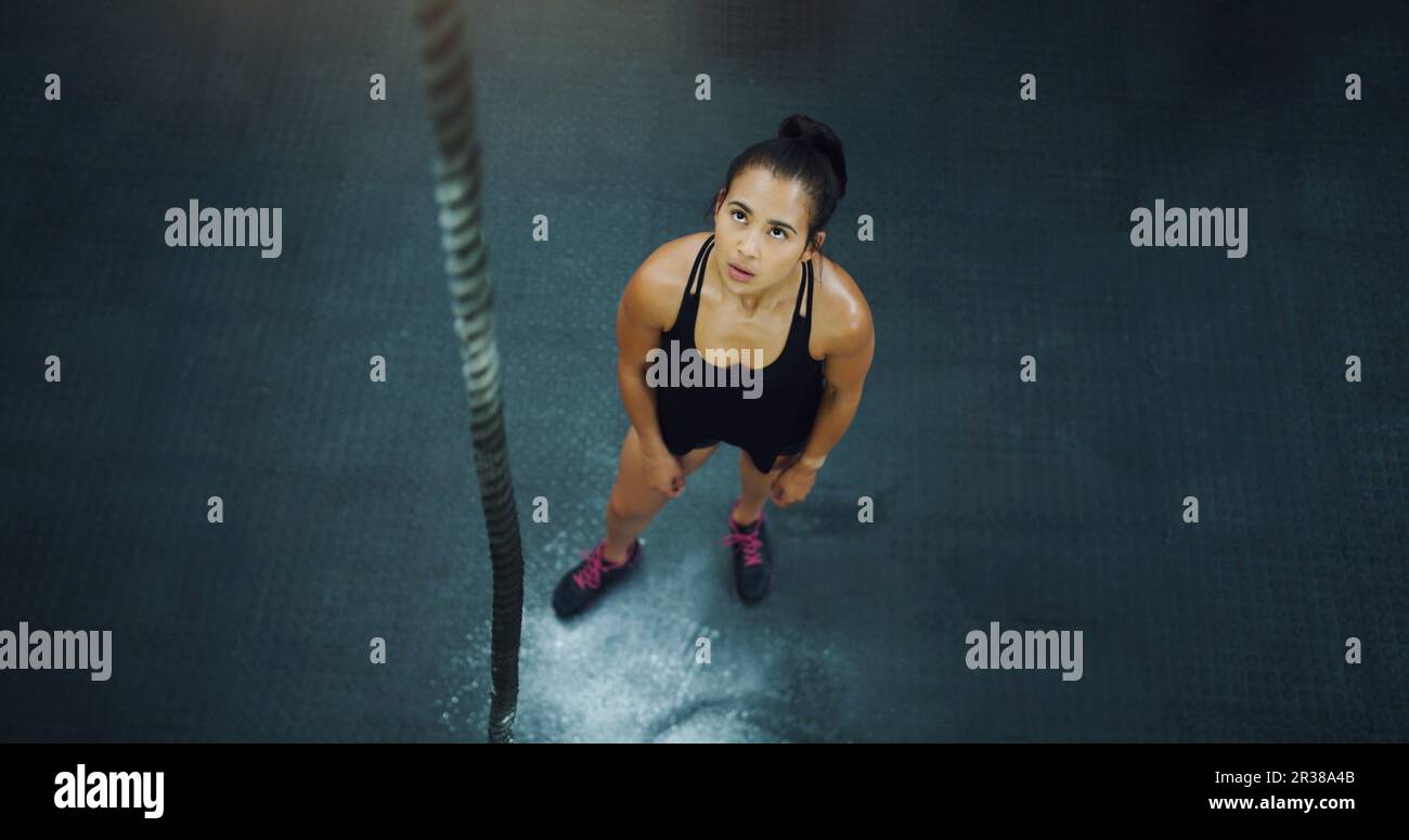 Rope climbing, woman and fitness at gym from above for training ...
